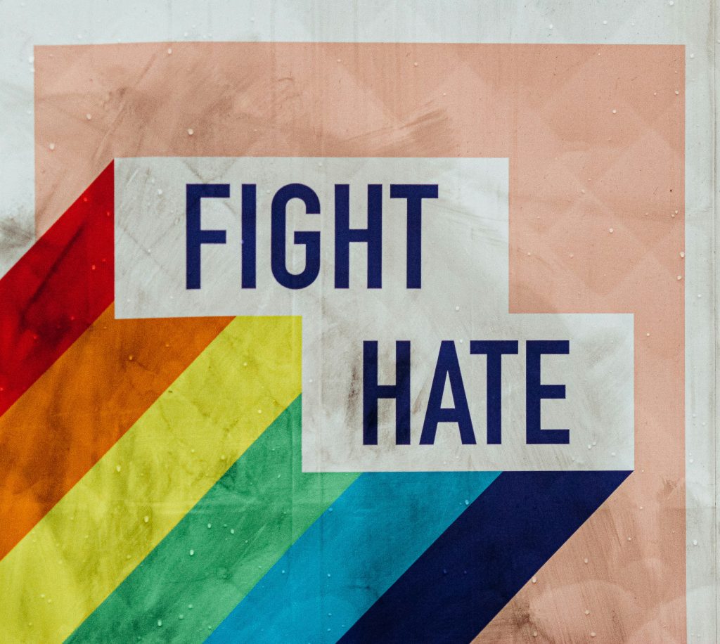 Part of the rainbow flag with the words Fight Hate written.